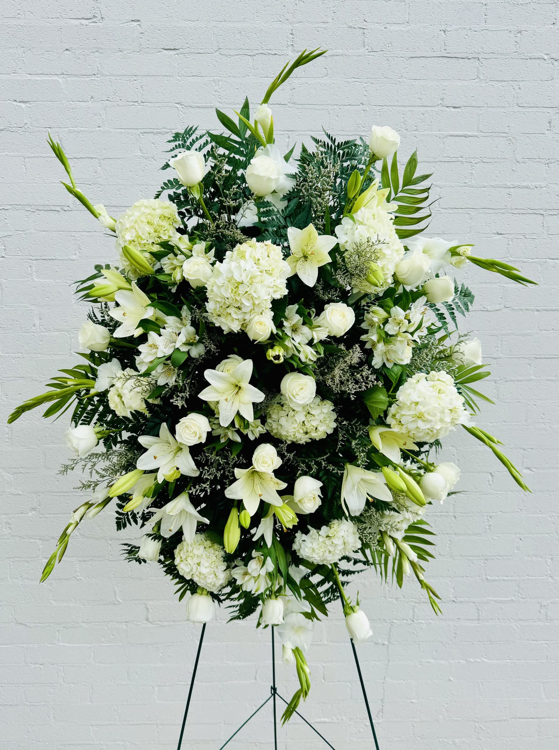 All White Sympathy Standing Spray - Send your deepest wishes of sympathy in an elegant way with our all-white standing spray.  Using the freshest all white roses, hydrangeas, lilies, gladiola's and more. Our all white sympathy standing spray is appropriate for funerals and memorial services.  36" Wide  60" Tall 