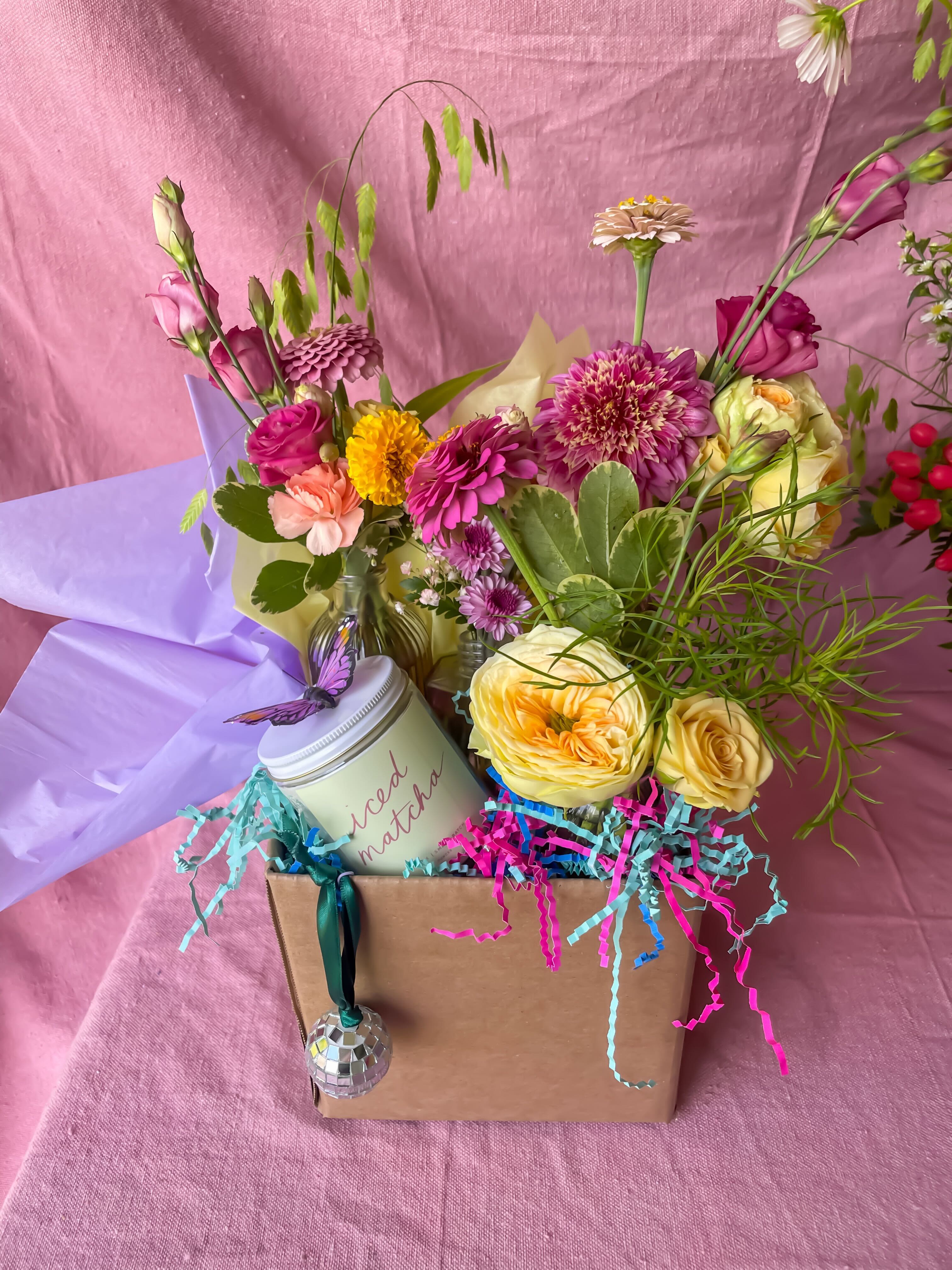 Mixed flower arrangement in a gift box with a candle and hanging ornament