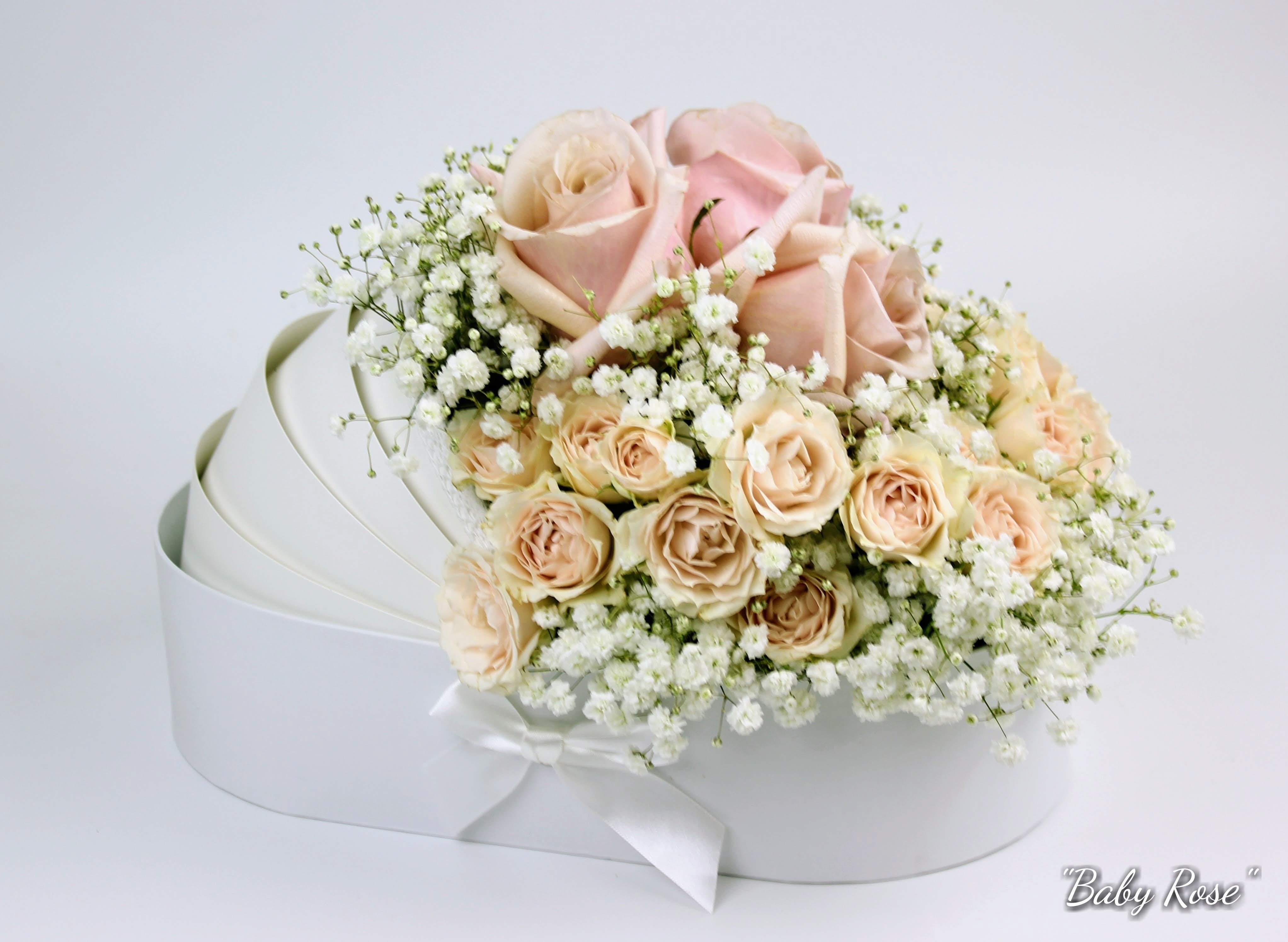Bouquet of pale pink roses and baby's breath in a white box