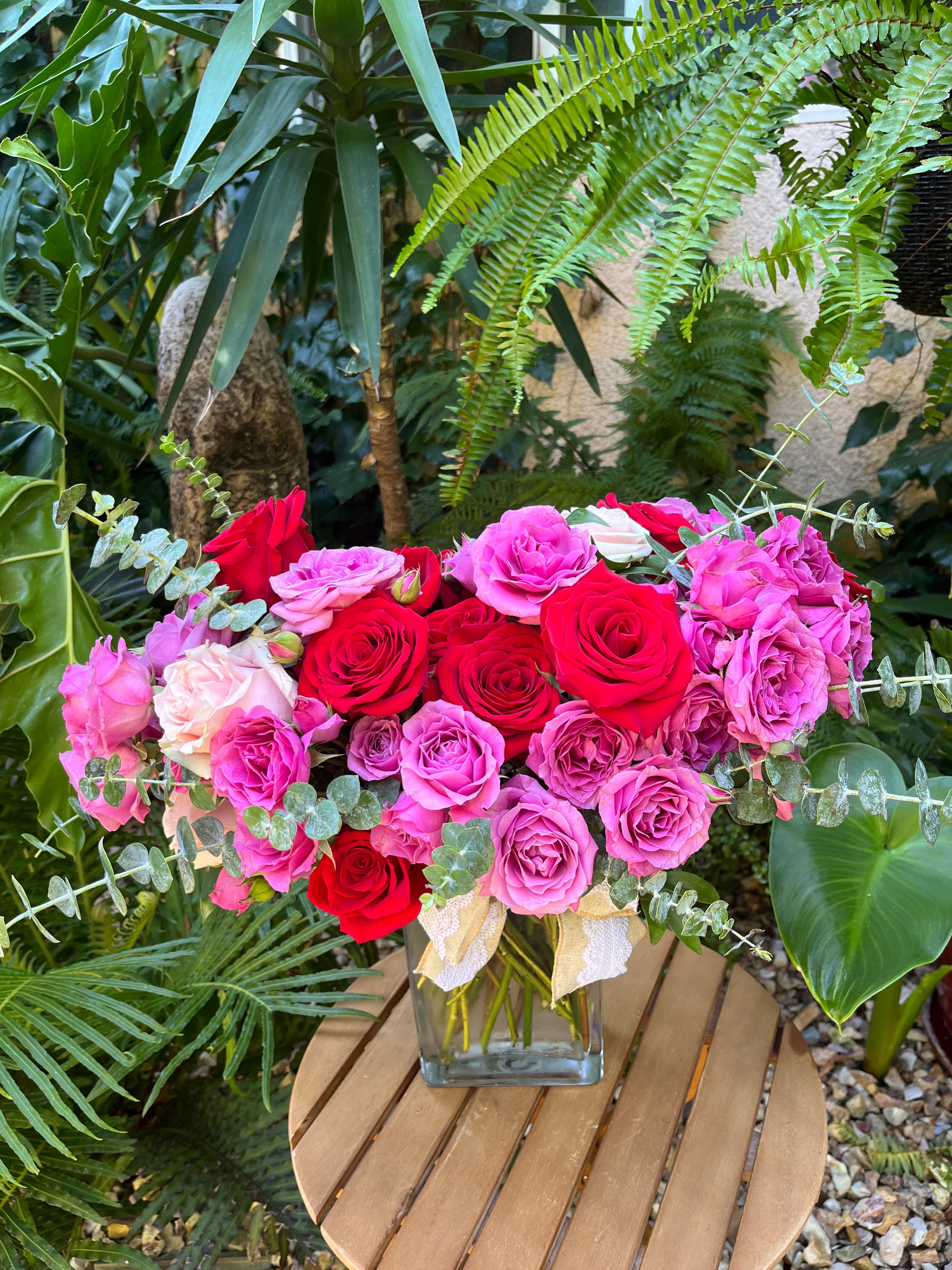 Bouquet of red and pink roses in a glass vase