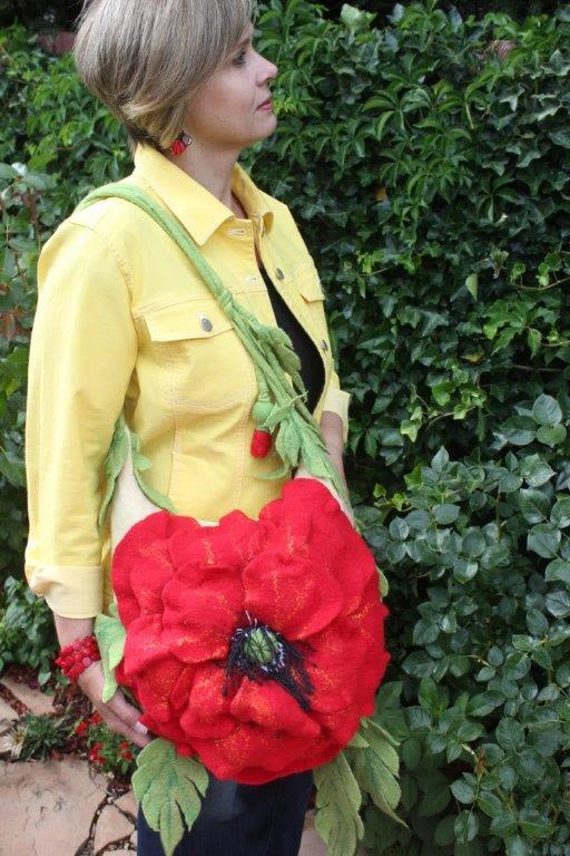 Woman wearing a large red flower-shaped crossbody bag