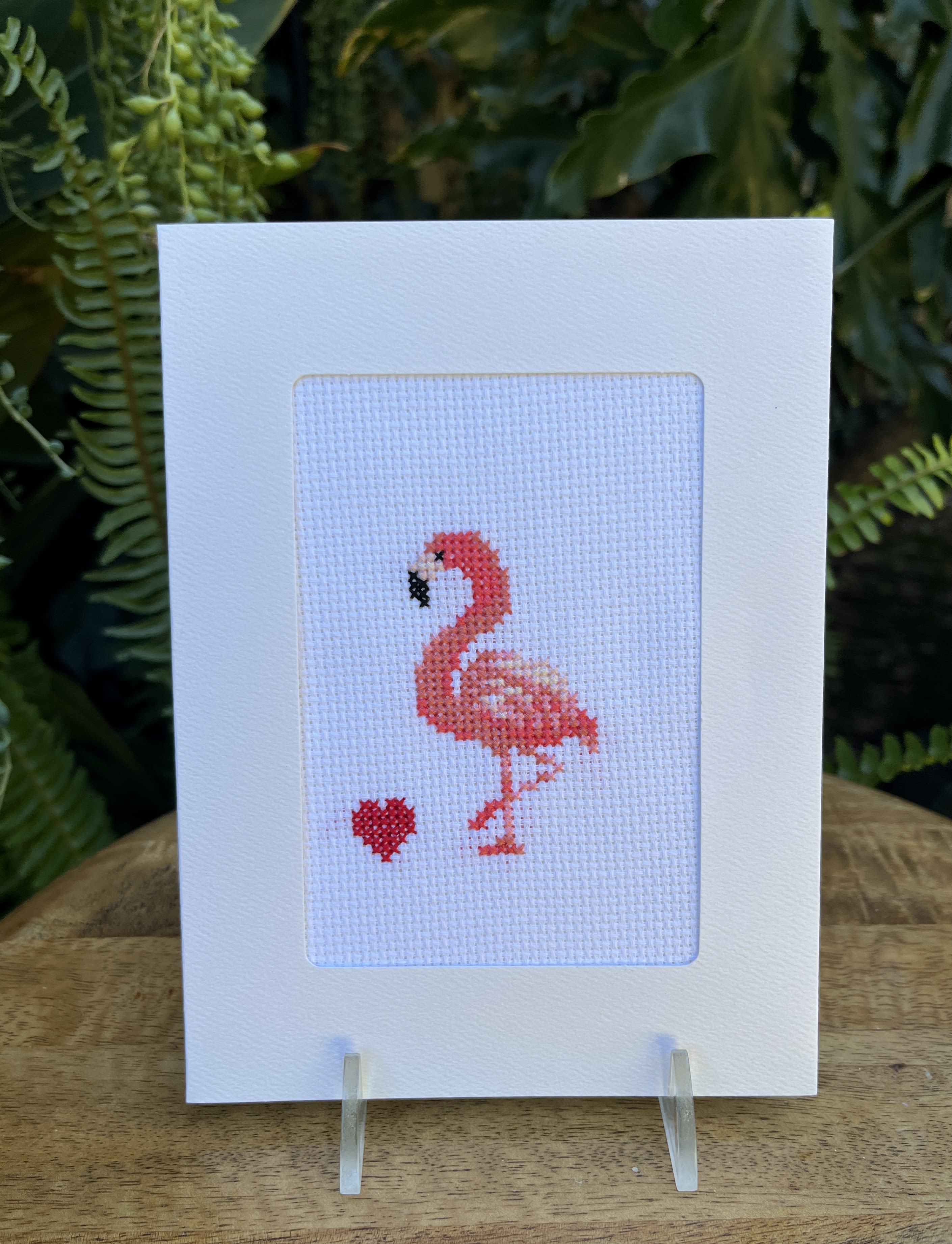Flamingo cross-stitch card on a clear stand