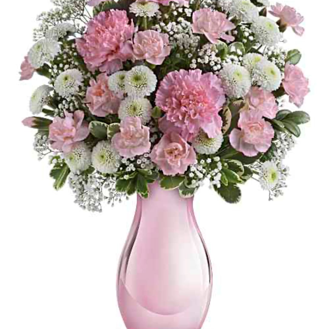 Pink and white flower arrangement in a pink glass vase