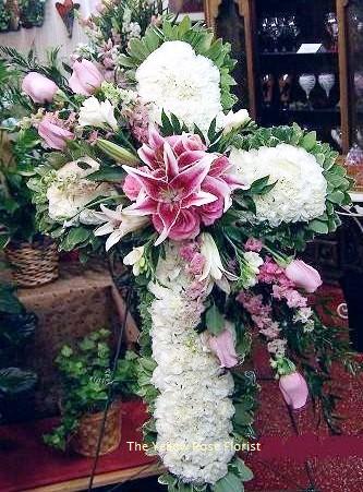 Large pink and white floral cross arrangement with lilies and hydrangeas