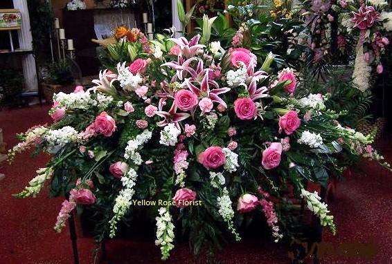 Large pink and white funeral spray with roses and lilies