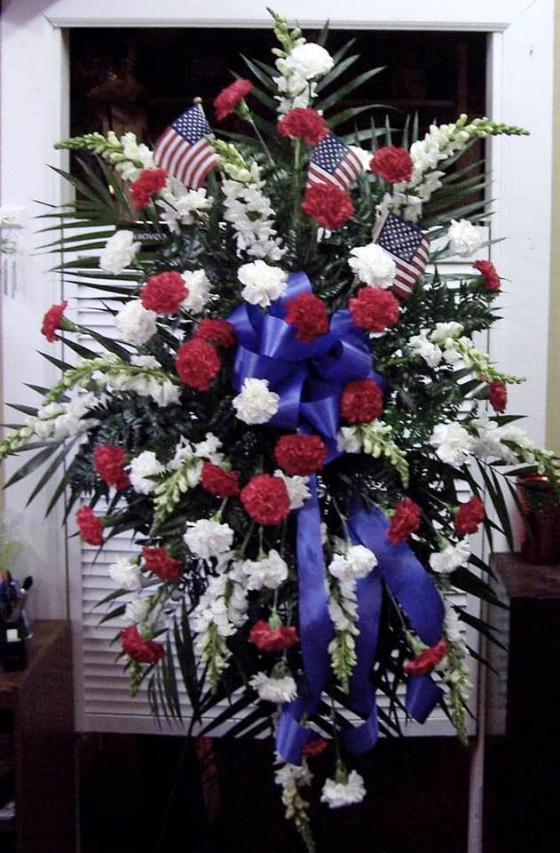Standing floral spray with red and white carnations and small American flags