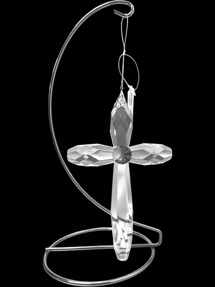Crystal cross ornament hanging on a silver metal stand