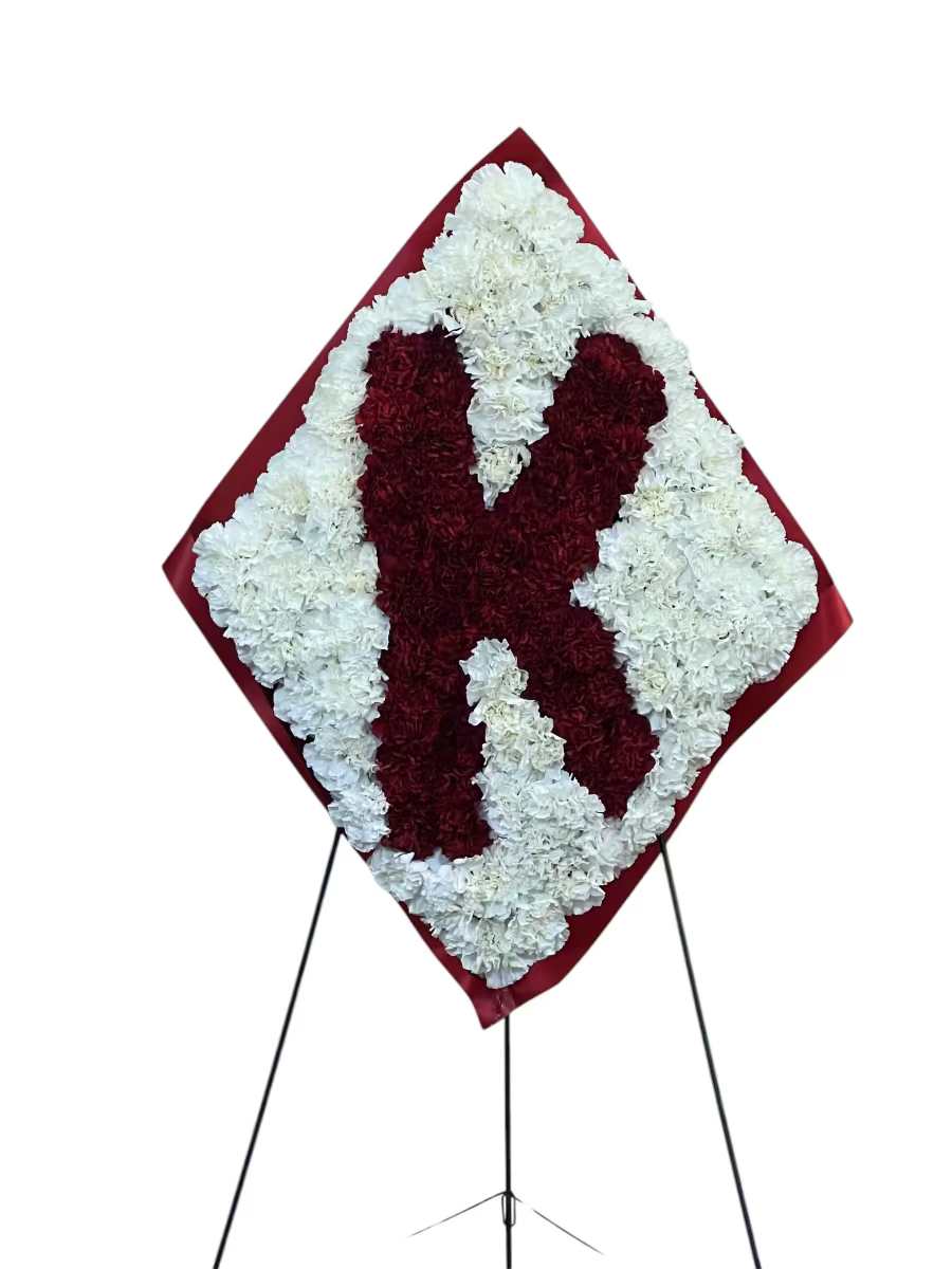 Heart-shaped floral standing spray in red and white on an easel
