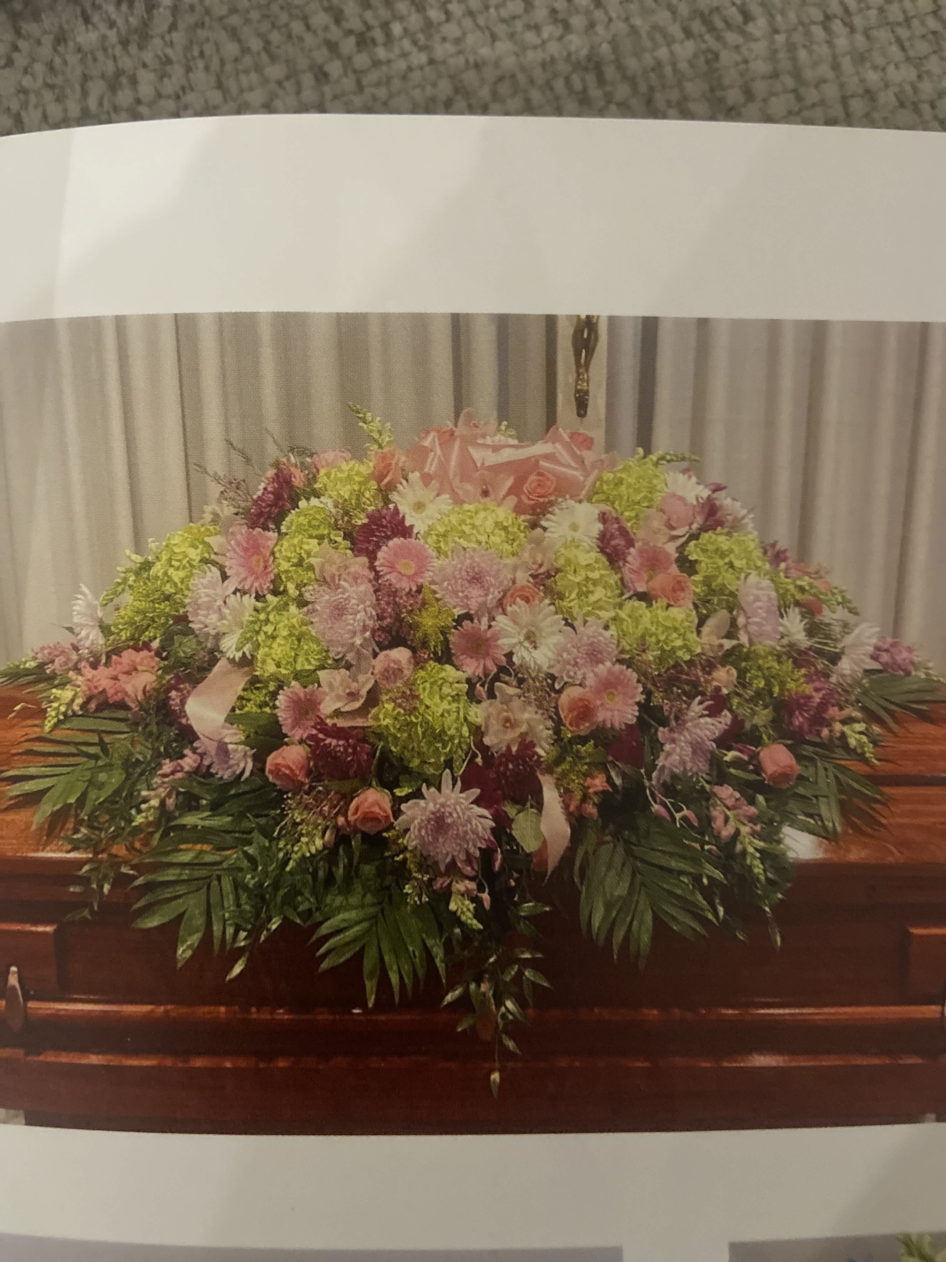 Large pink and green floral casket spray with mixed blooms