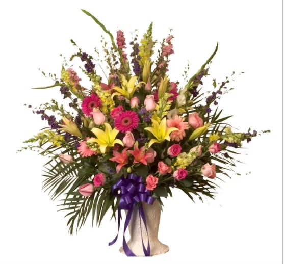 Large mixed bouquet with pink roses, lilies, and gerbera daisies in a wrapped base