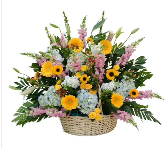 Basket arrangement of yellow, pink, and white flowers