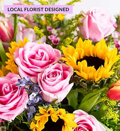 Pink roses and yellow sunflowers in a mixed bouquet