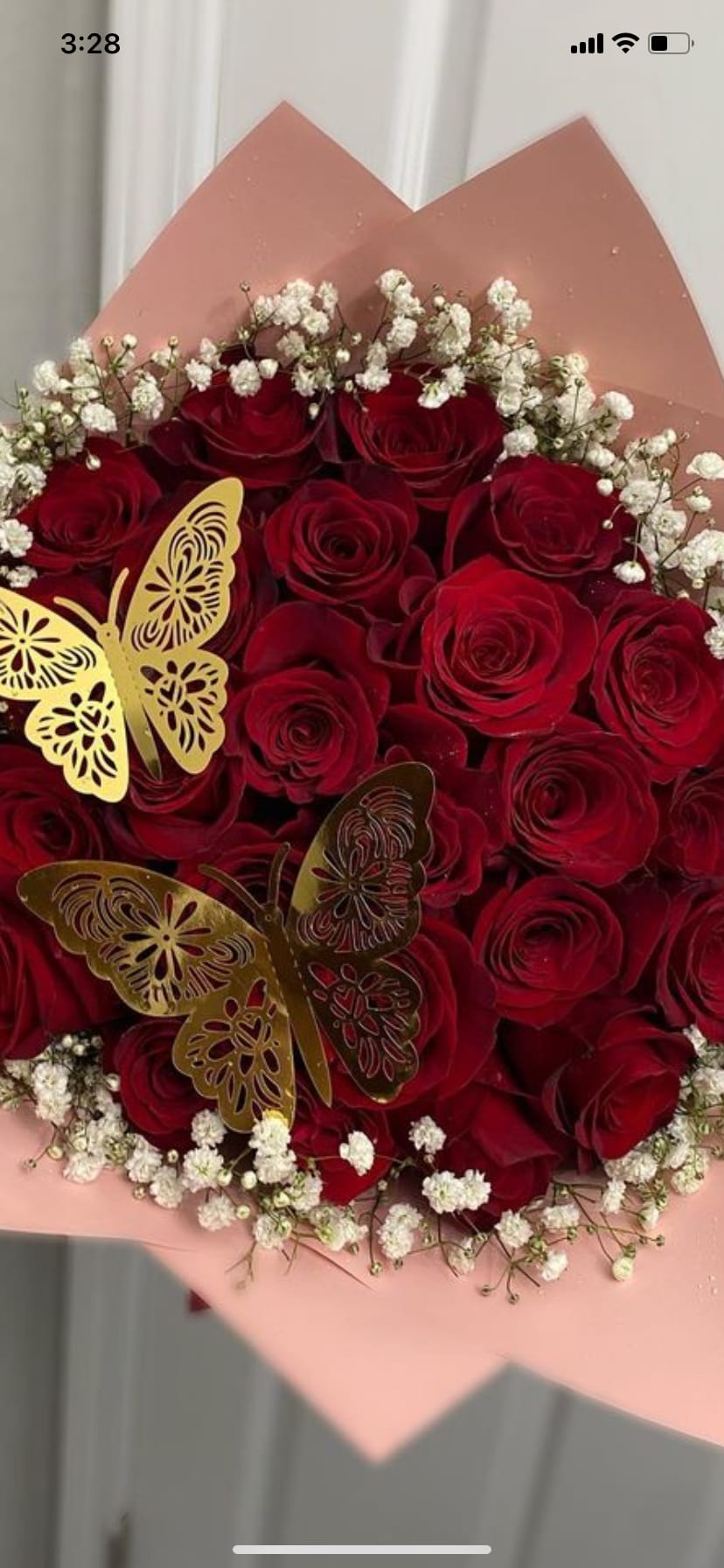Bouquet of red roses with white baby's breath and gold butterfly accents
