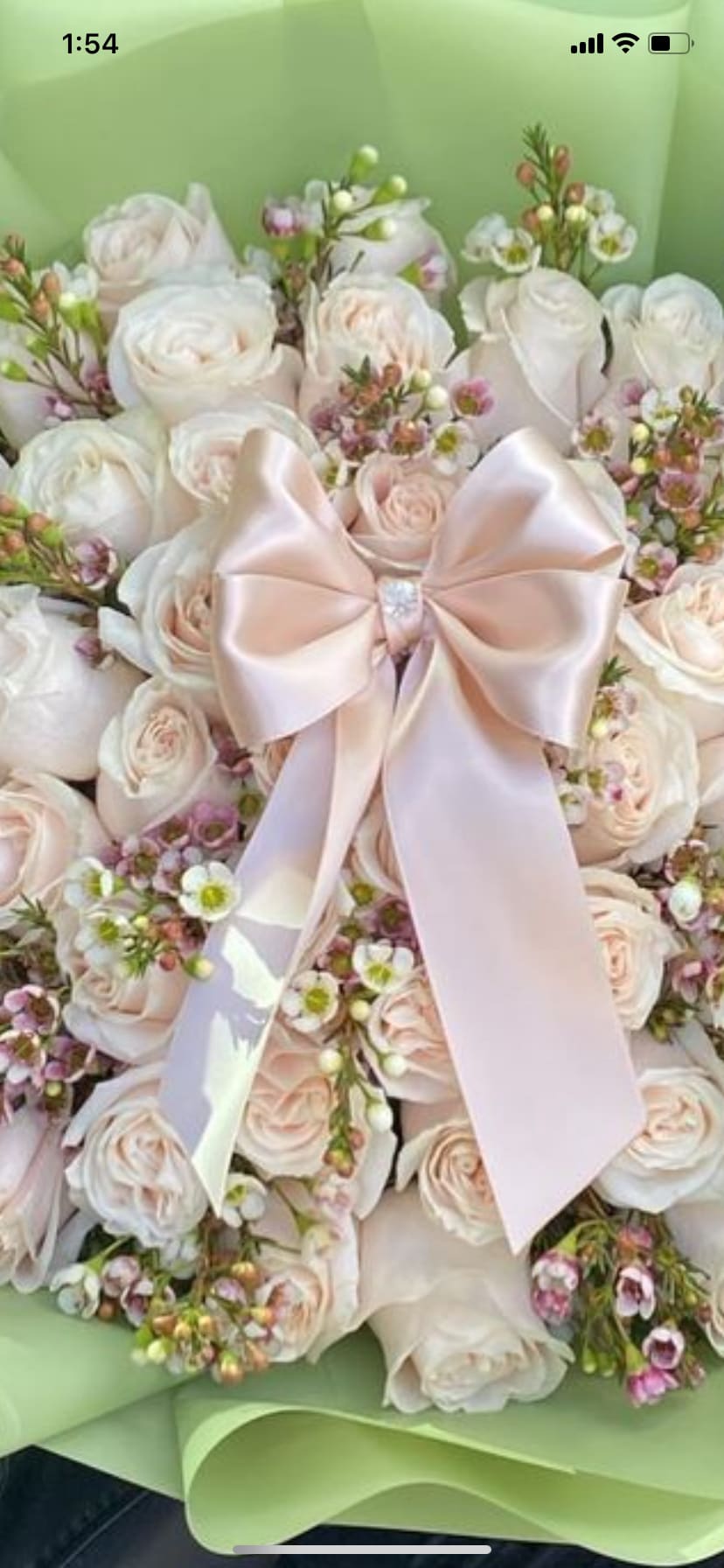Bouquet of pale pink and white roses with a satin bow