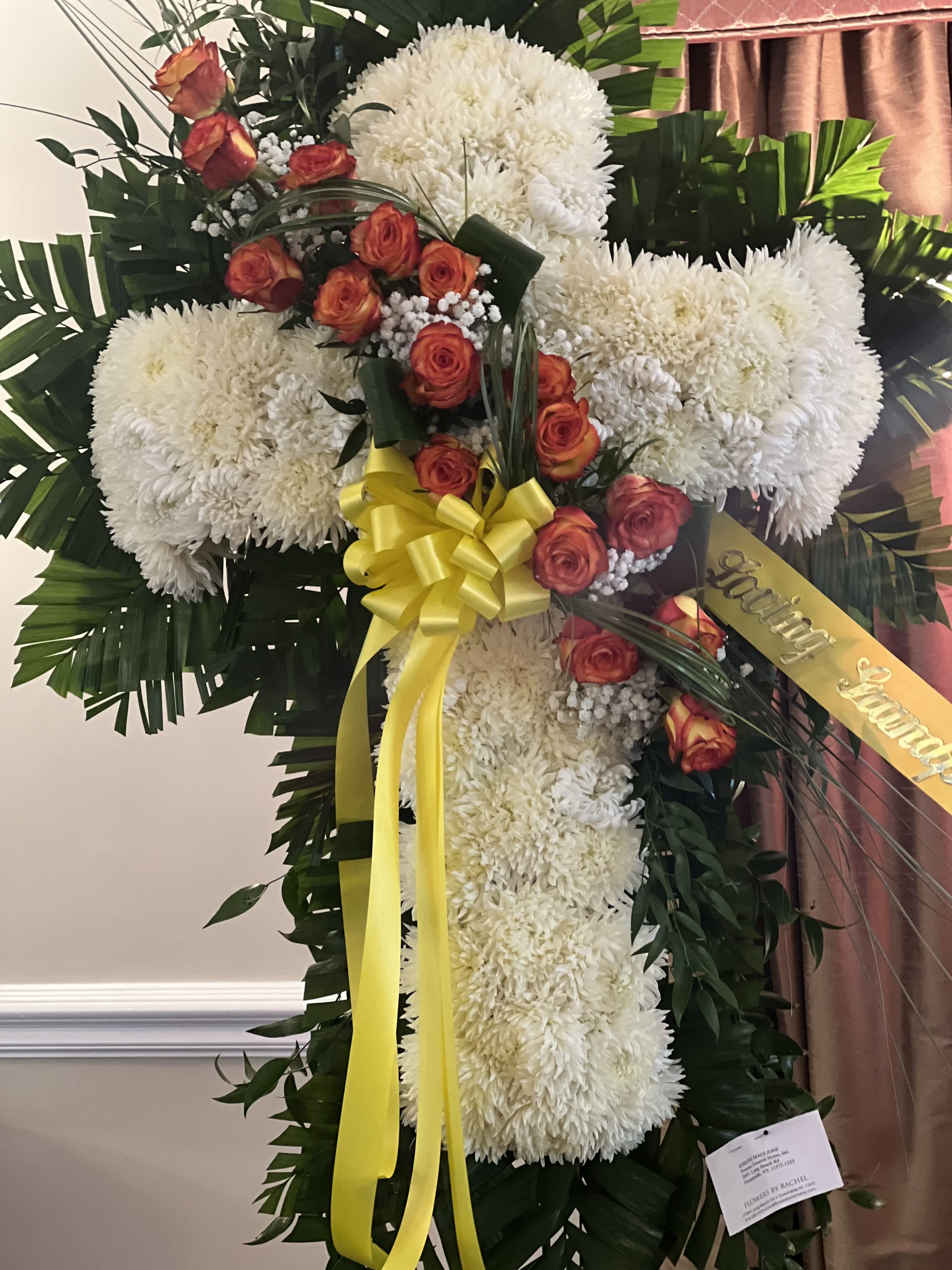 Large floral cross with white chrysanthemums and orange roses