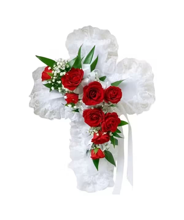 White floral cross with red roses and ribbon