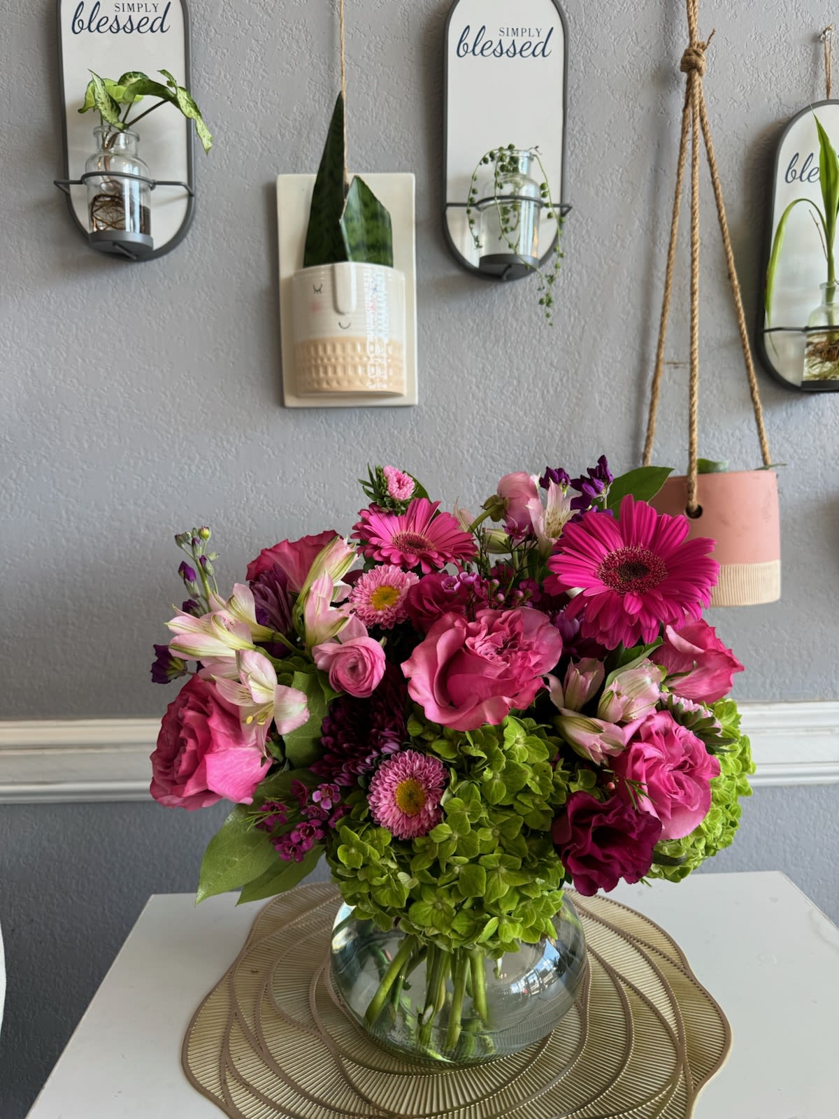 Pink and magenta flower arrangement in a glass vase
