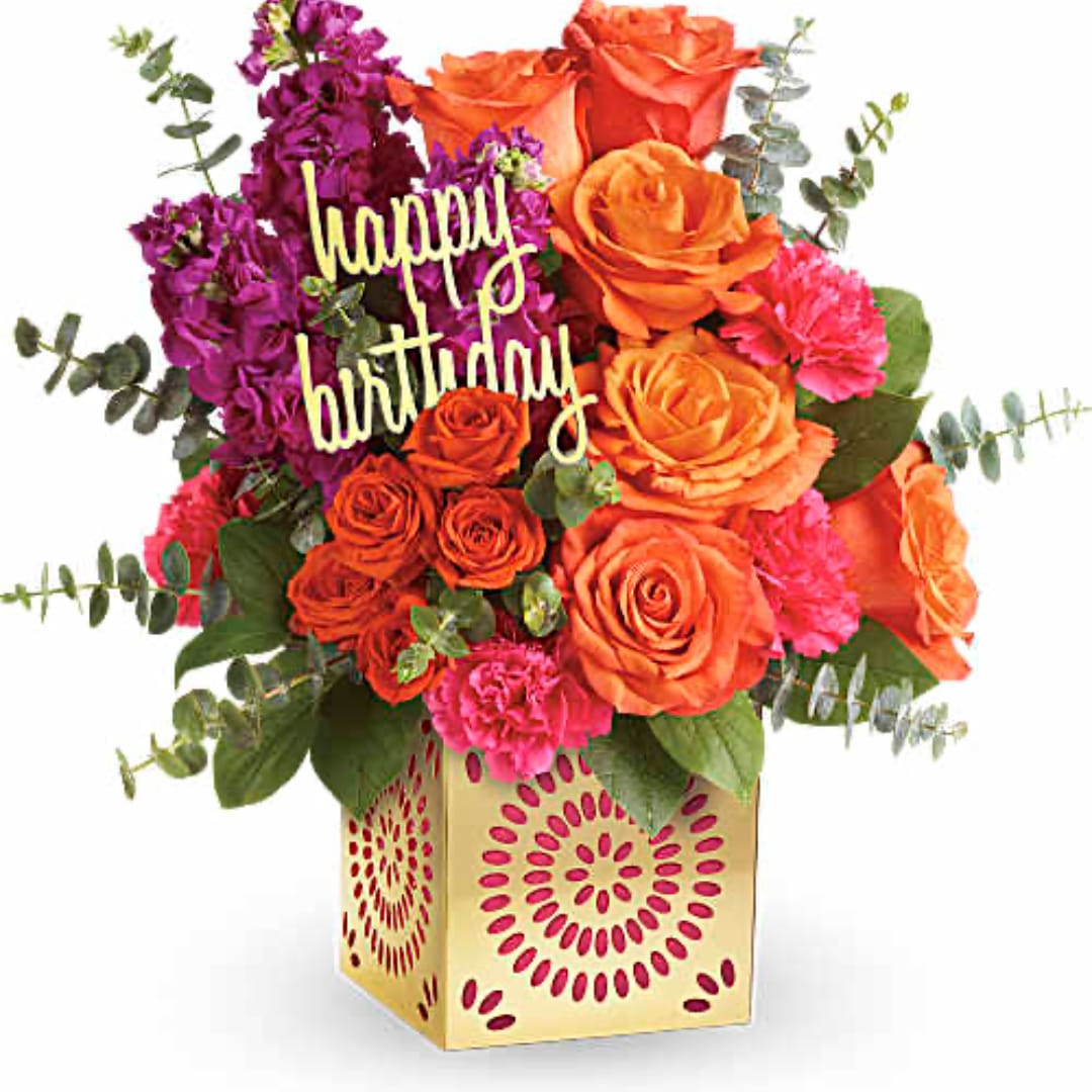 Orange and purple rose bouquet in a patterned gold box with a happy birthday sign