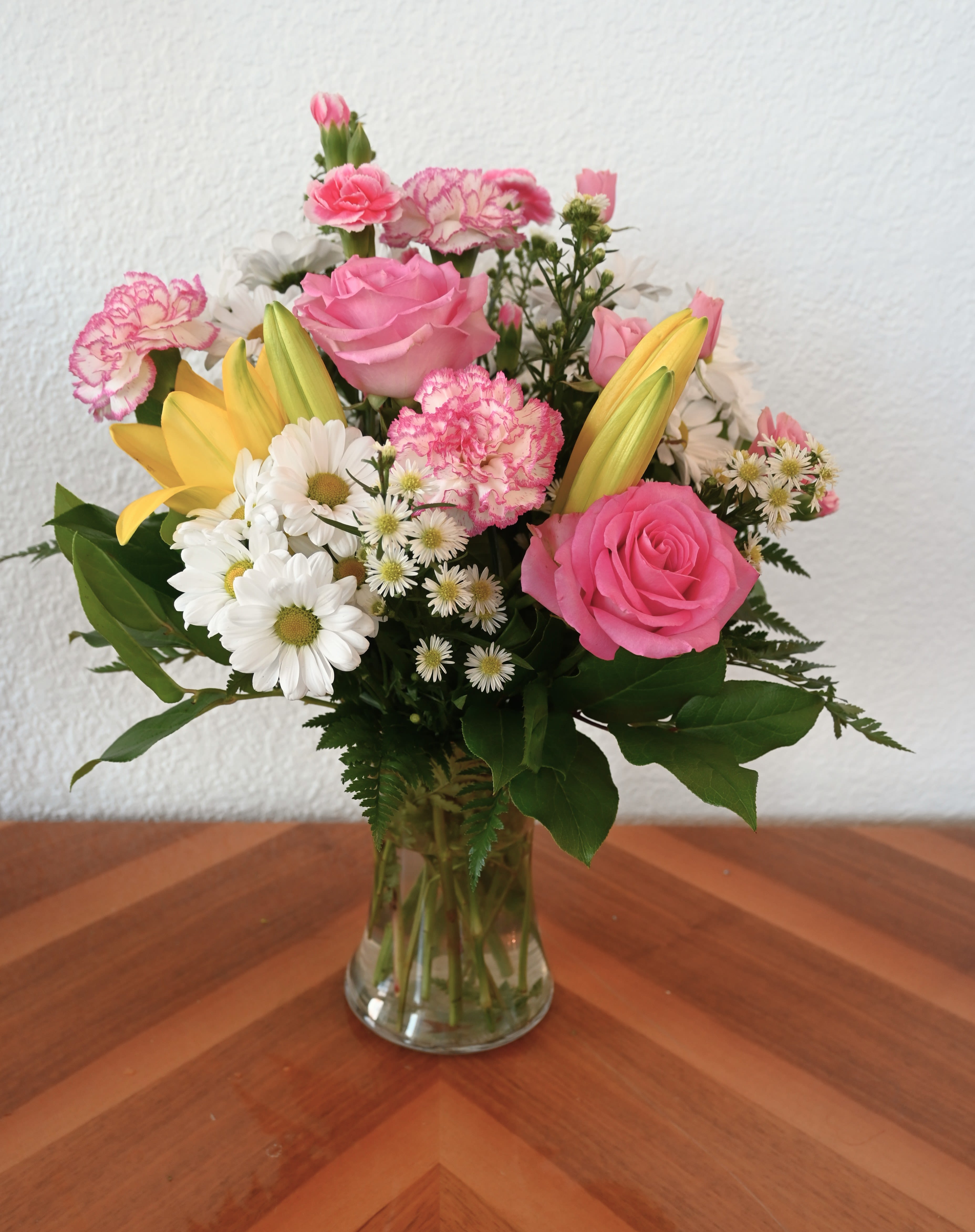 Spring Sensation - Bring in spring with fresh flowers! A lovely collection of pink, yellow, and white flowers is the perfect way to welcome a new season.