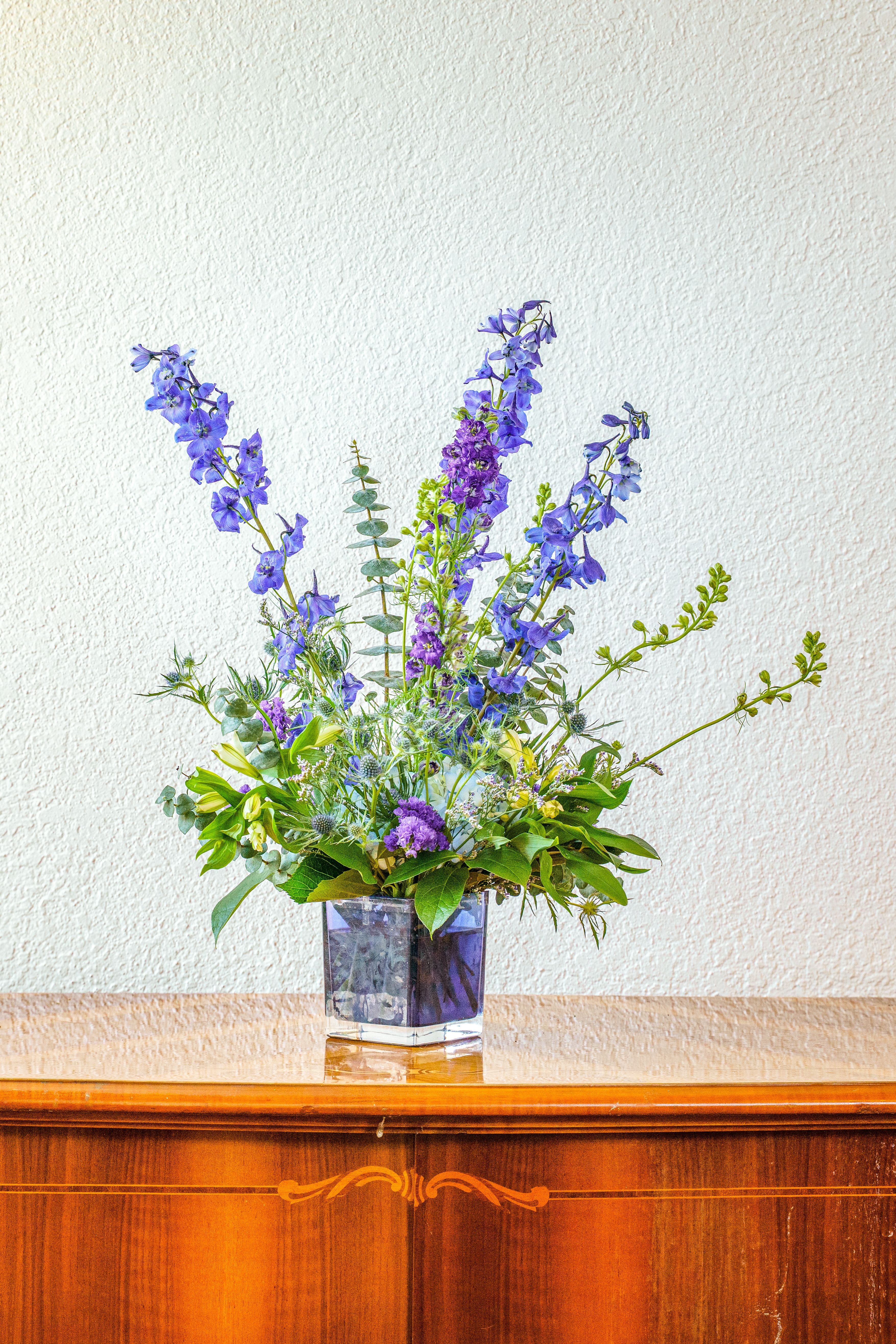 Sapphire Sky - The sky's the limit! This impressive, monochromatic design is sure to turn heads. Send them this bold, beautiful arrangement made entirely of vibrant blues to say thank you, celebrate a birthday, or simply let them know you're thinking of them.