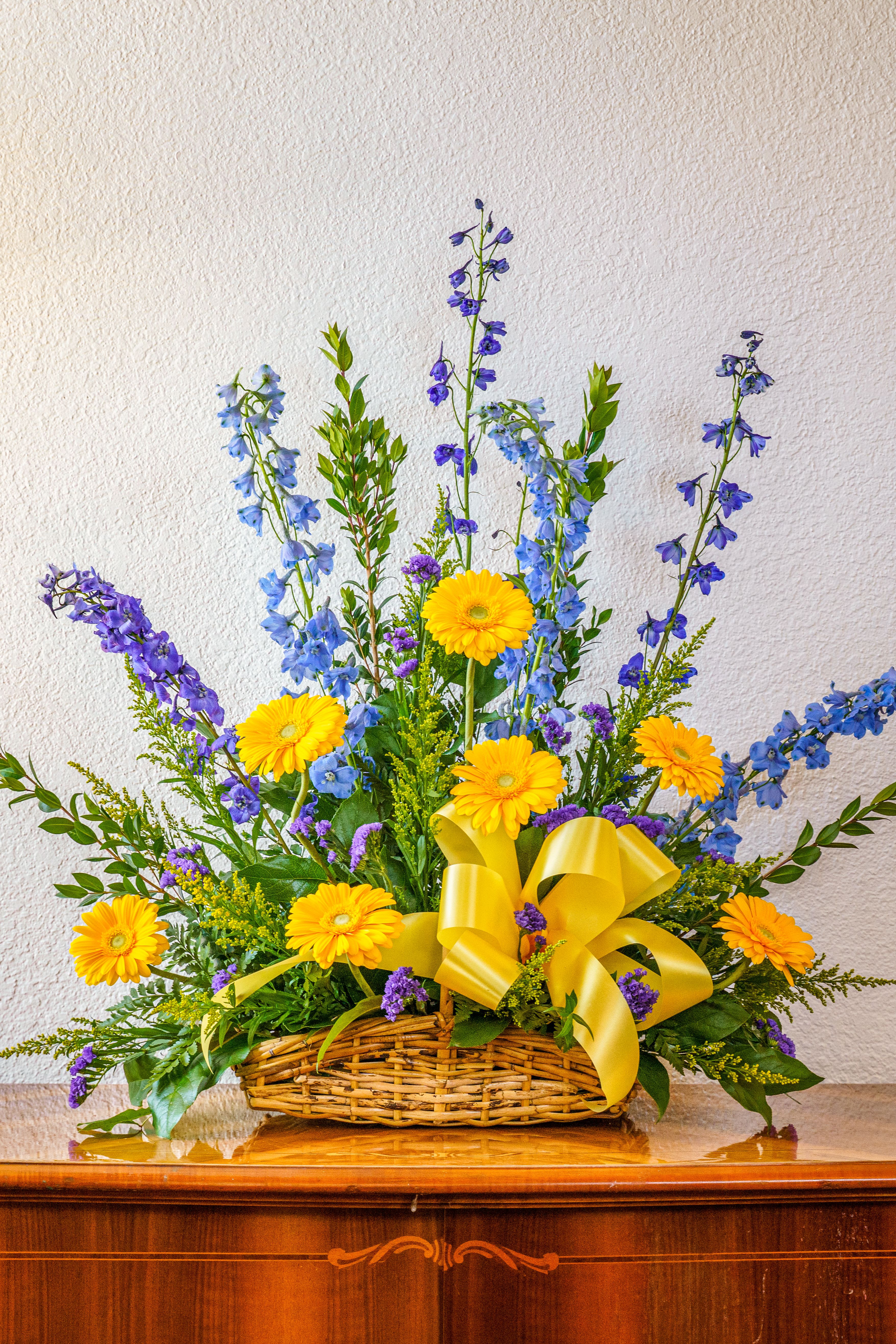 Fond Memories - Celebrate a life well-lived with a cheery assortment of blue and yellow. This delightful basket will lift spirits and honor fond memories that will be cherished forever.