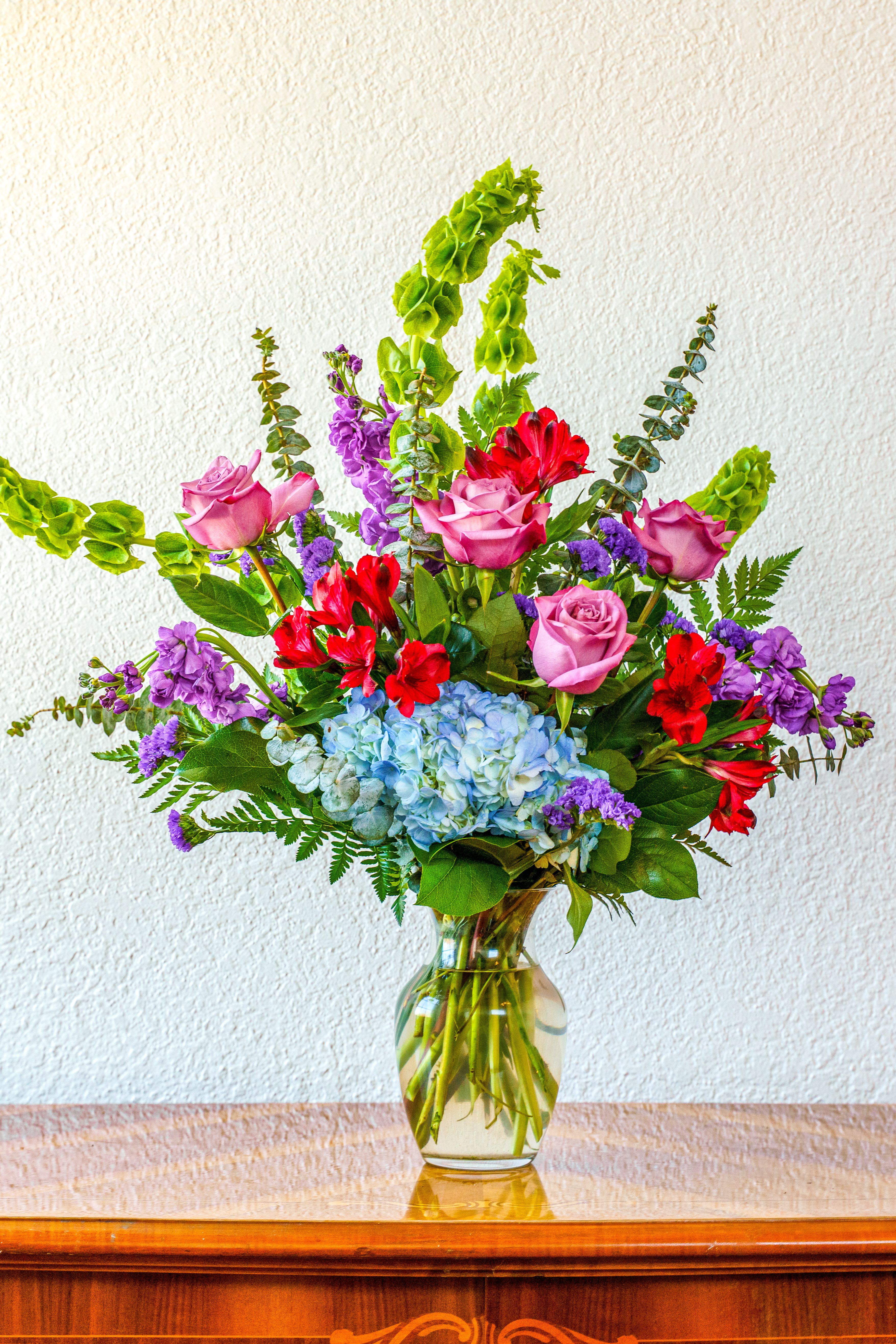 The Promenade - Send them a luxurious Euro-style bouquet that is sure to impress! This lavish collection of hydrangea, roses, stock, and more is guaranteed to blow them away.