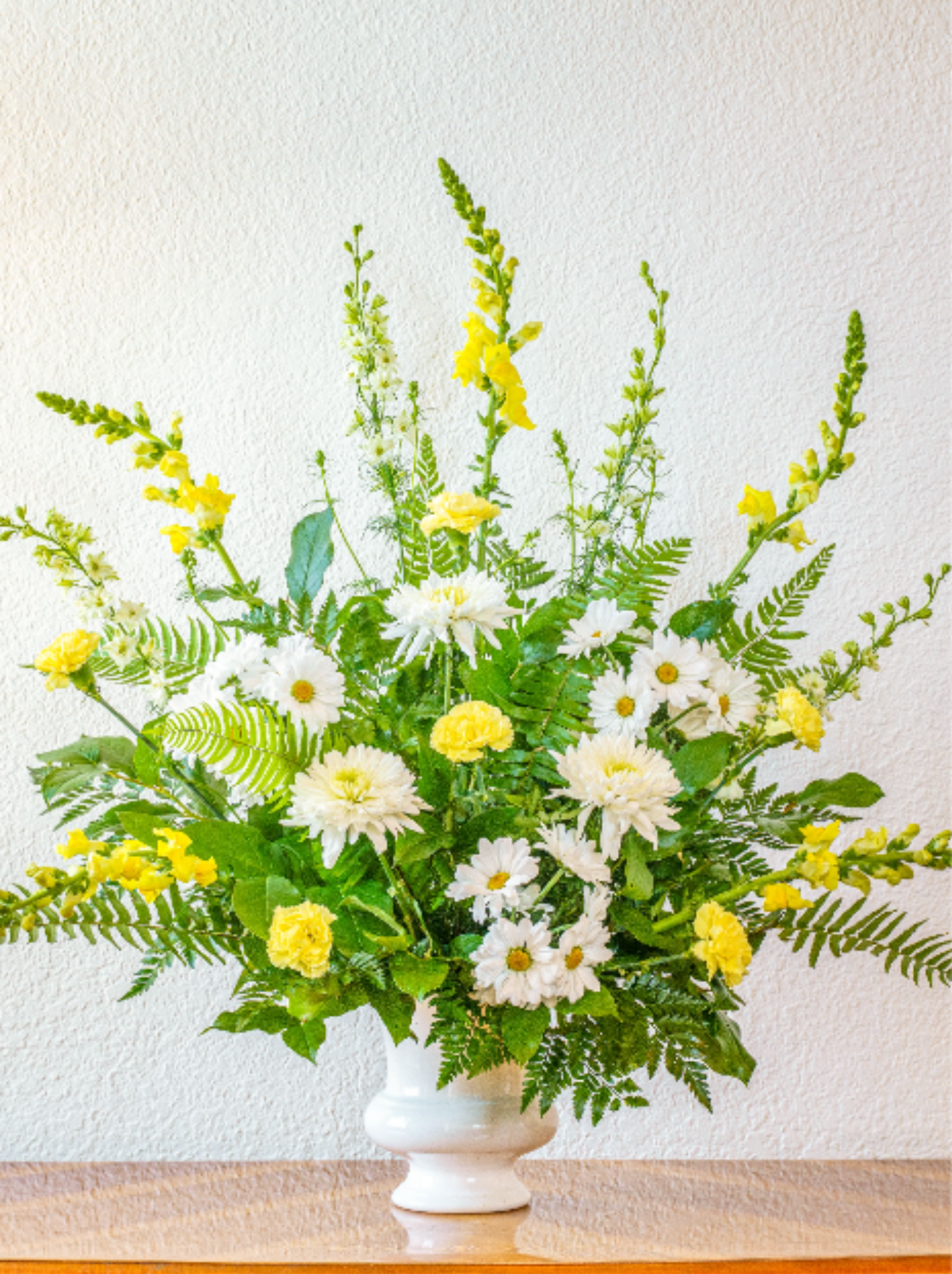 Golden Love - Remember the life of someone very special. This lovely arrangement is sure to be appreciated as it gently warms the hearts of all who see it.  Available for the addition of a bow with or without script.