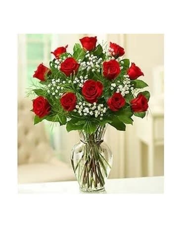 Red roses arranged in a clear glass vase