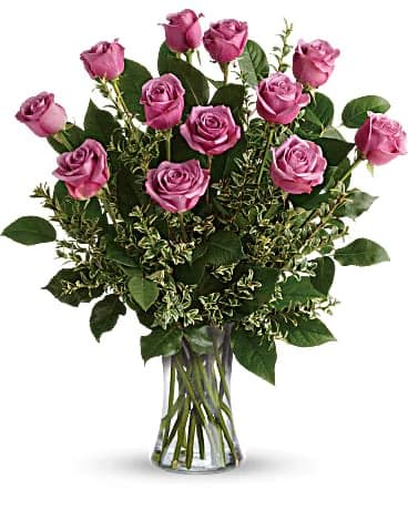 Pink roses arranged in a clear glass vase