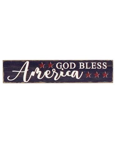 Long rustic wooden sign reading God Bless America with red stars on a dark background