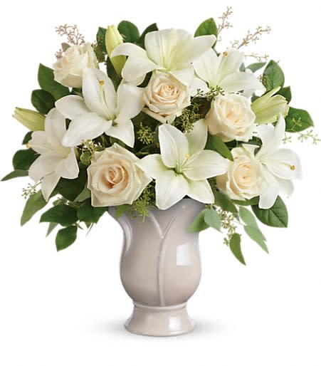 White lilies and cream roses in a gray vase