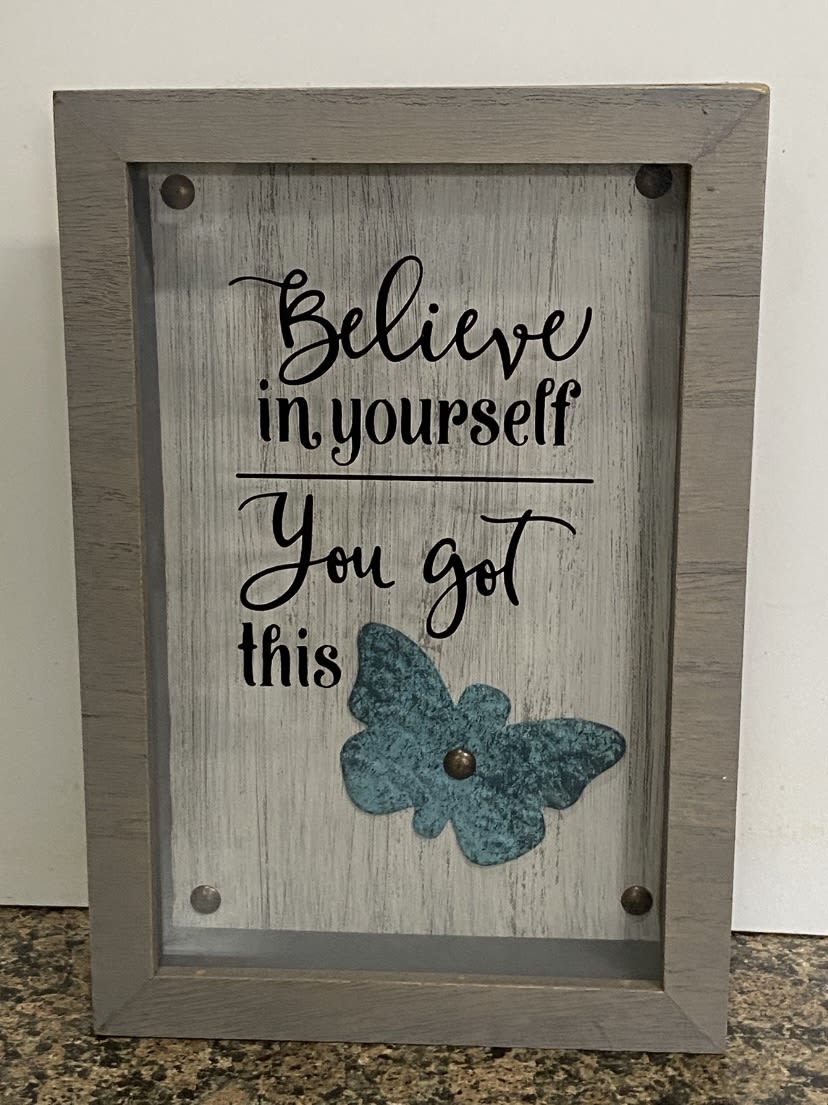 Framed rustic sign with “Believe in yourself You got this” text and a teal butterfly accent.