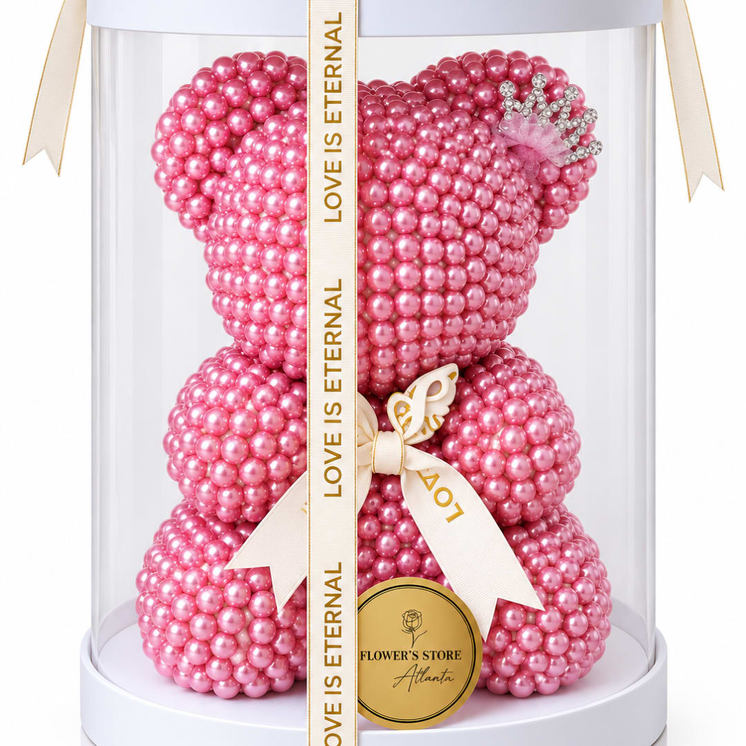 Pink pearl teddy bear in a clear gift box with a ribbon