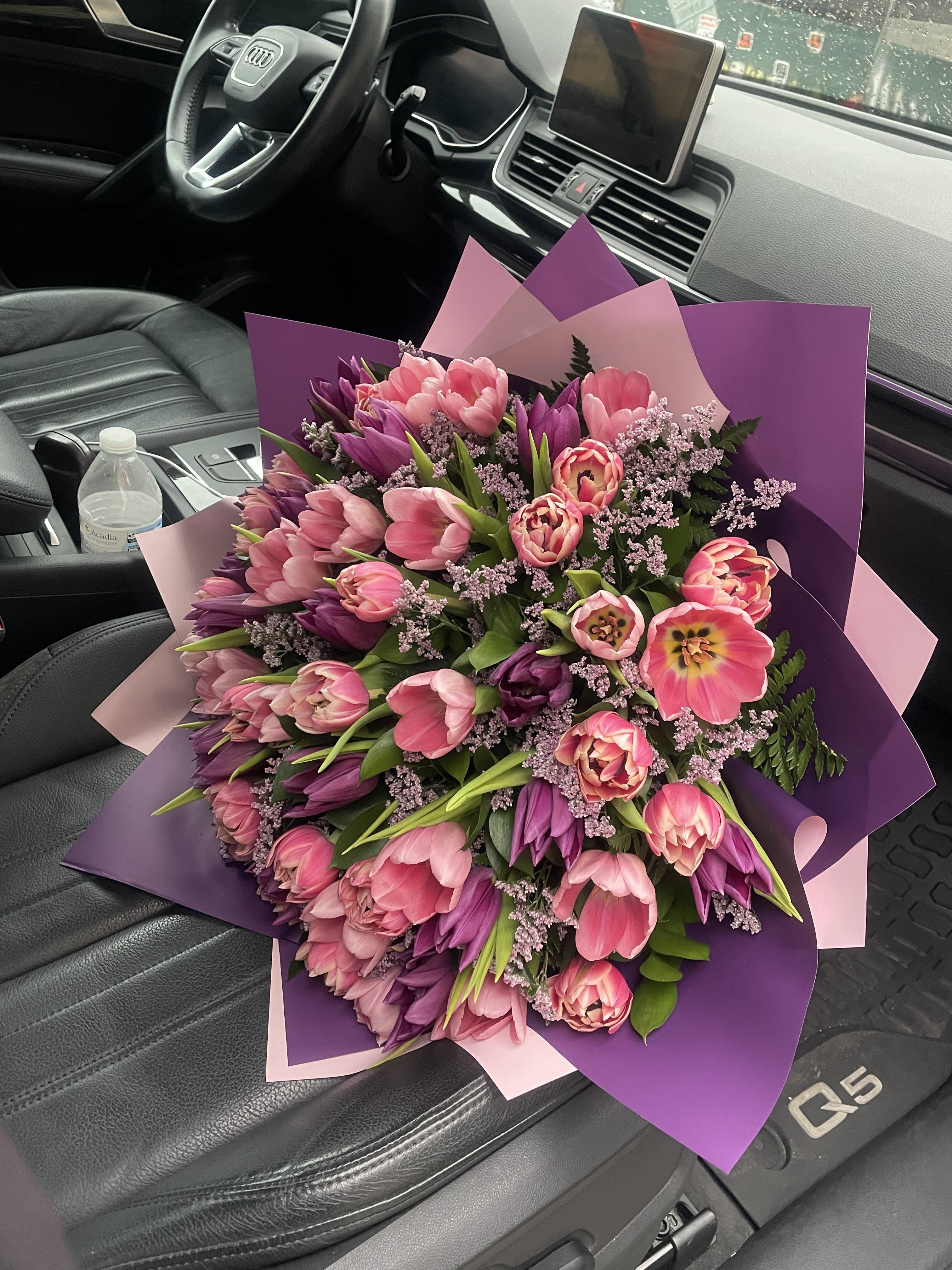 Large bouquet of pink and purple tulips wrapped in pink and purple paper