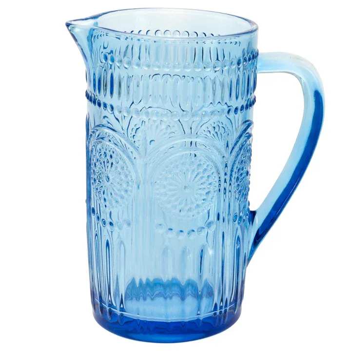 Blue glass pitcher with an embossed floral pattern