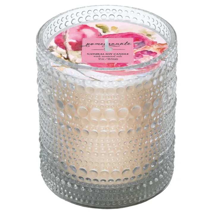 Scented candle in a textured glass holder with a floral lid label