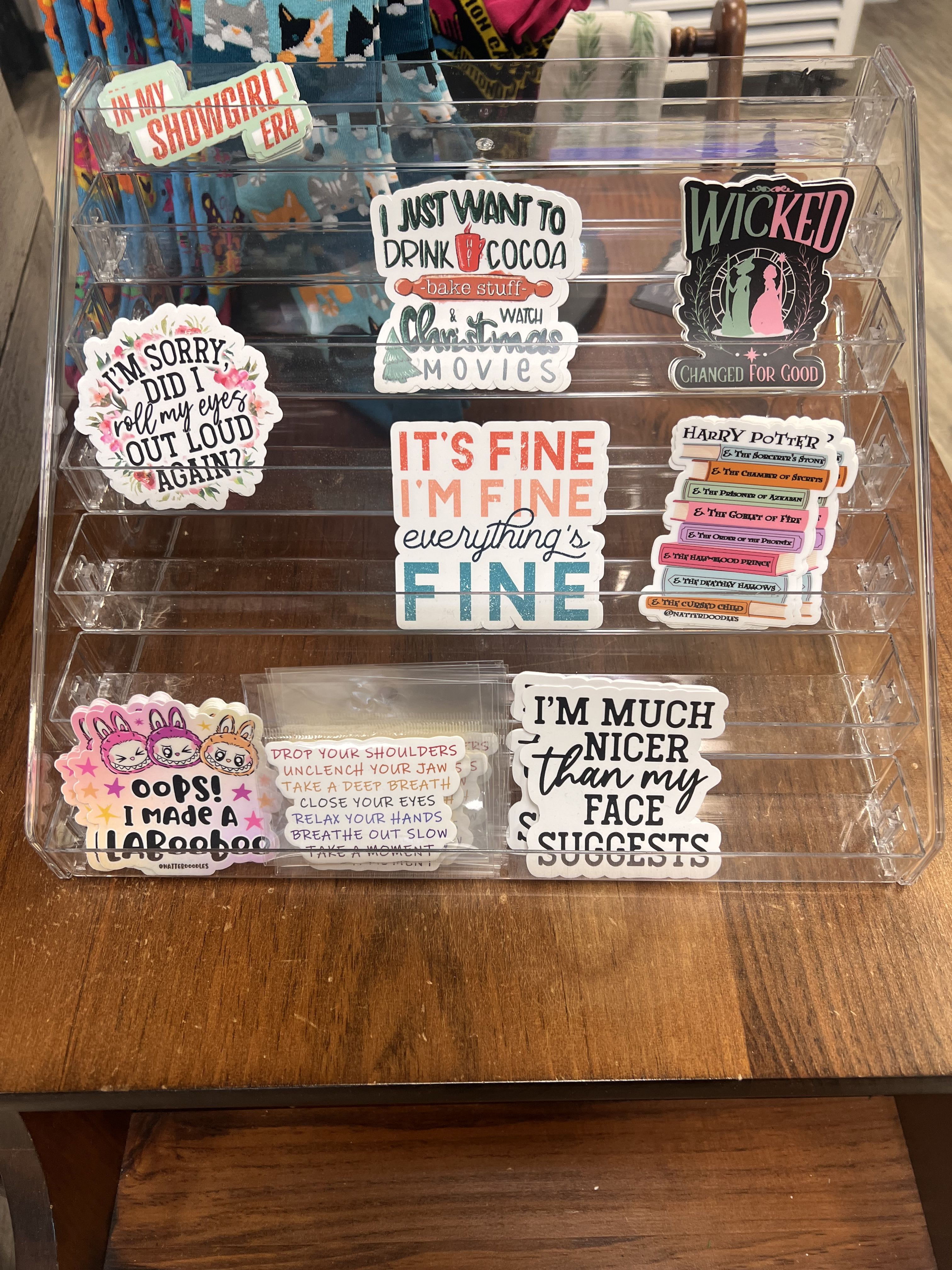 Clear acrylic display rack holding assorted decorative stickers and decals