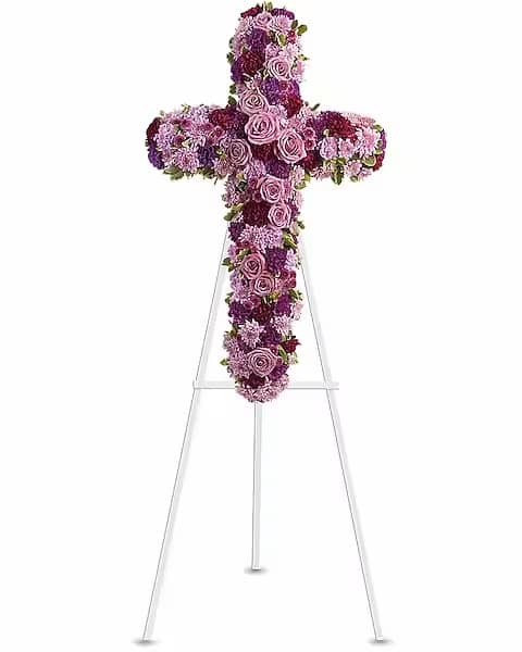 Purple and pink floral cross on a stand