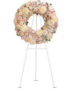Pastel floral wreath on a white stand