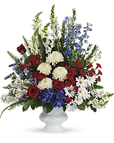 With Distinction Urn - ***MUST BE ORDERED 3 BUSINESS DAYS IN ADVANCE. PLEASE CALL US DIRECTLY TO SEE ABOUT SOONER ACCOMMODATIONS..***  A dazzling display of patriotic red, white and blue flowers sends a silent yet poignant statement about hope, freedom and the strength to endure. This proud bouquet is a testament to life that is sure to be appreciated. A beautiful mix of all-American red, white and blue flowers such as hydrangea, roses, miniature carnations, snapdragons, chrysanthemums and more are perfectly arranged in a white urn. Orientation: One-Sided