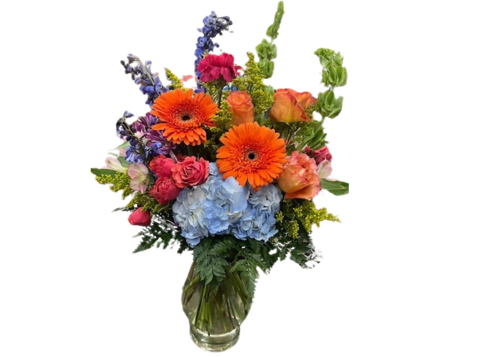 Mixed bouquet with orange gerbera daisies, blue hydrangeas, and roses in a glass vase