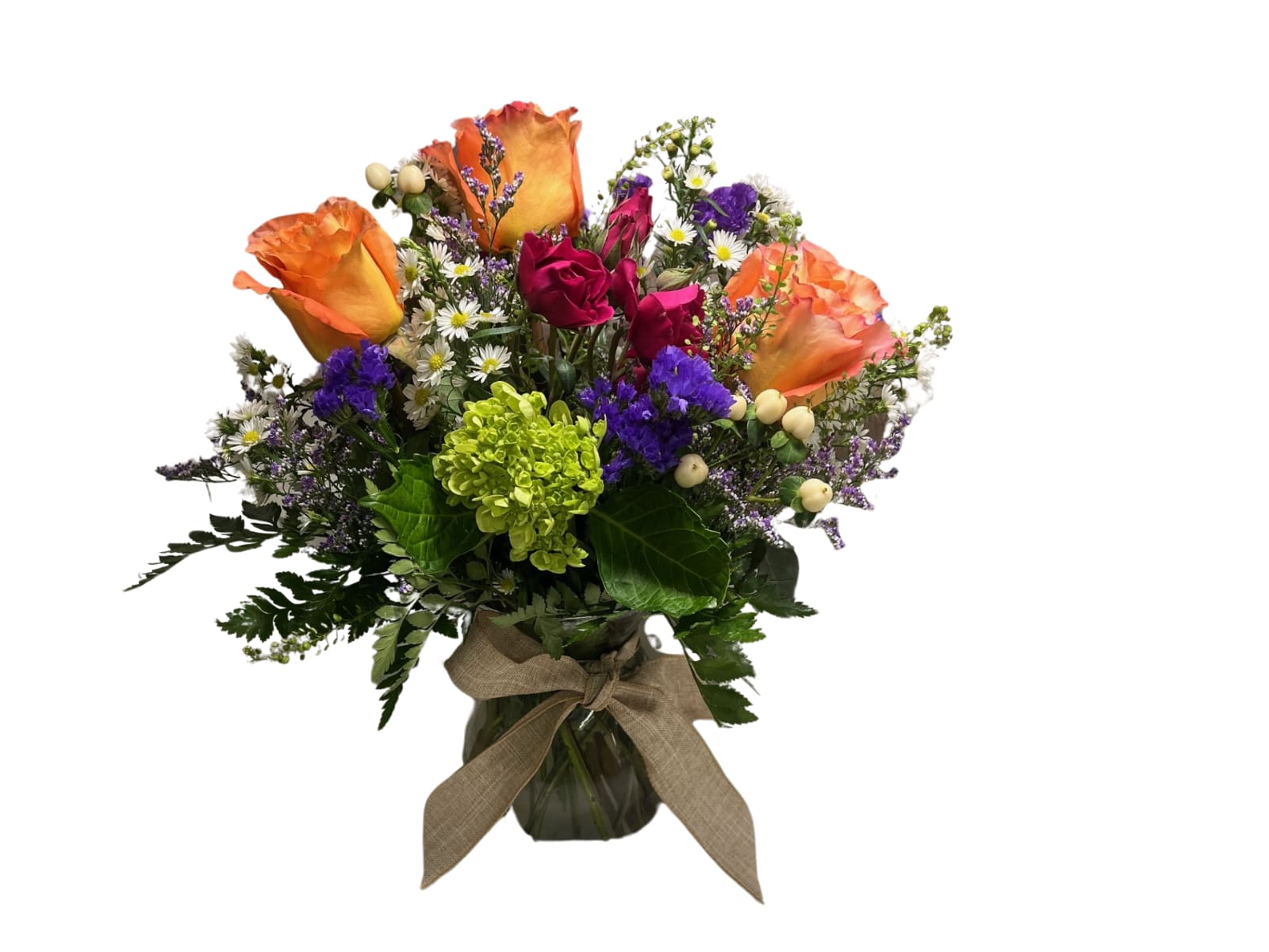 Bouquet of orange and pink roses in a glass vase with a ribbon