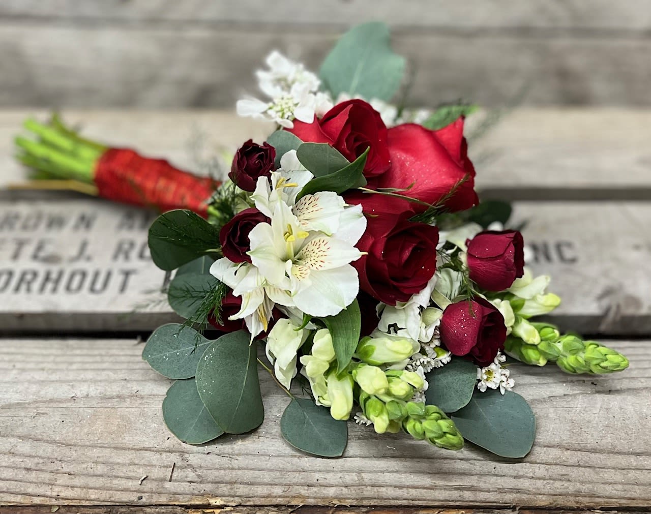 Bouquet of red roses and white flowers with eucalyptus