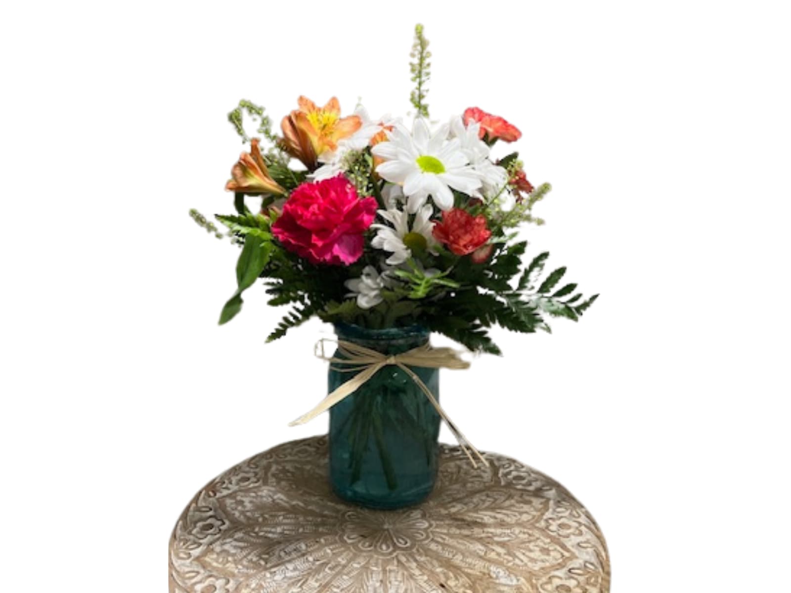 Mixed bouquet of daisies, carnations, and lilies in a blue glass vase