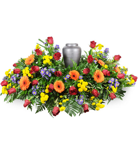 Colorful funeral wreath with a silver urn in the center