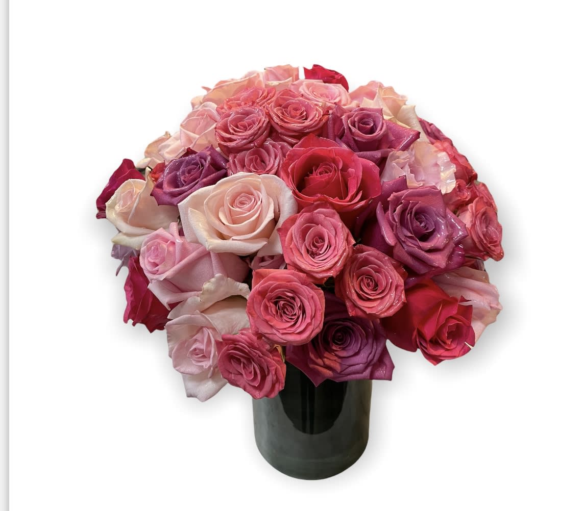 Bouquet of pink and red roses in a dark vase