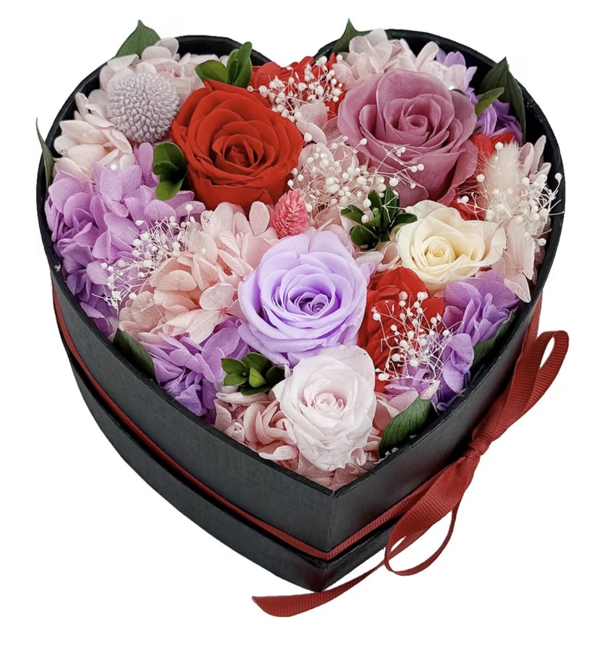 Heart-shaped black box filled with red, pink, lavender, and white roses and mixed blooms