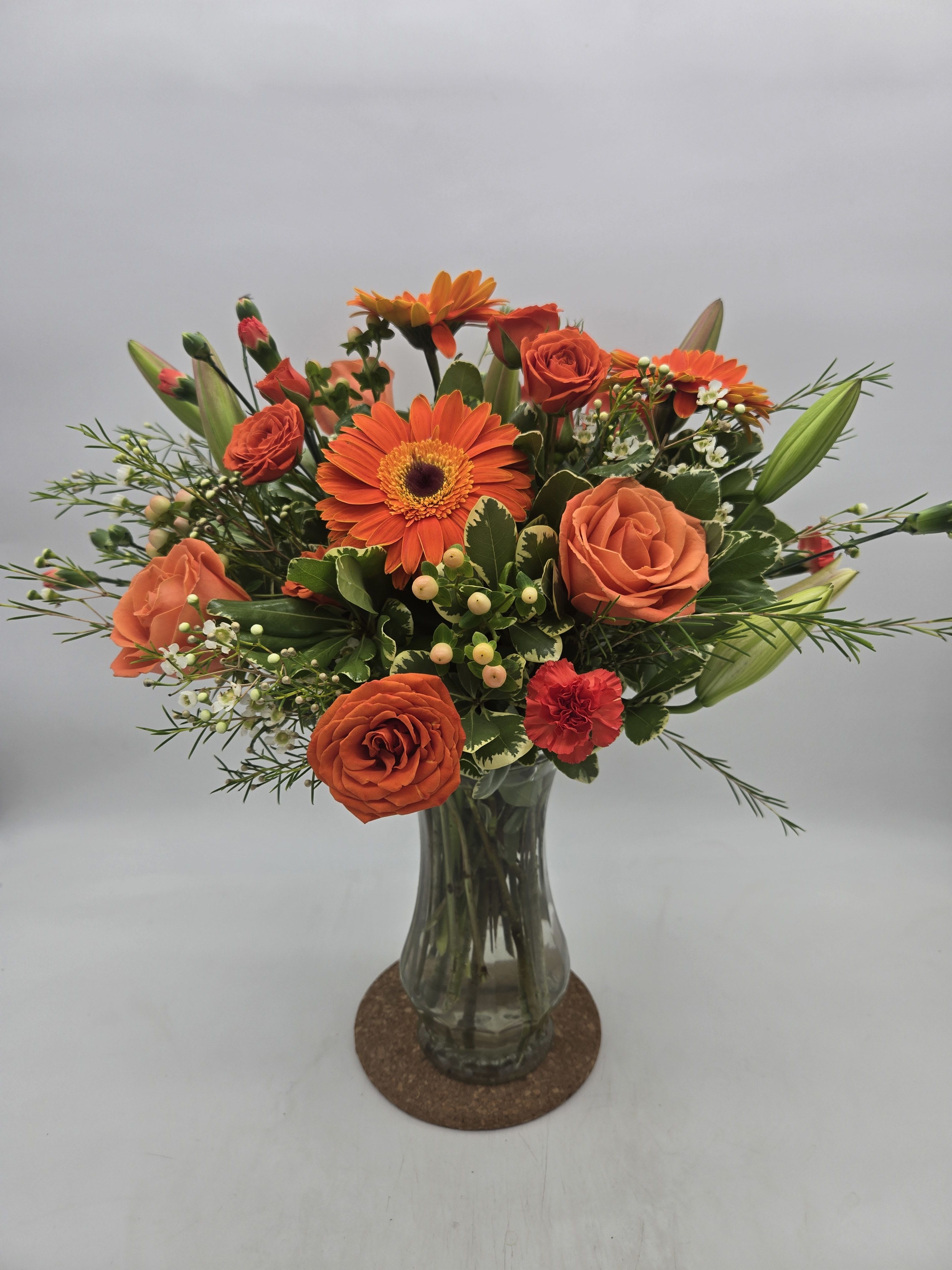 Orange Creamsicle - - Lilies - Spray Roses - Snapdragons - Hypericum Berries - Alstroemeria - Poms With all the things to love about Autumn, this bouquet tops the list. This arrangement features orange and peach blooms with assorted greens