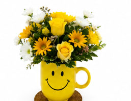 Be Happy Bouquet With Roses  - There are probably a million reasons this is such a popular bouquet. Of course, there are probably just as many reasons to send this cheerful arrangement. Full of happy flowers, this ceramic happy face mug will bring smiles for years to come. Especially when filled with that first cup of morning coffee or cocoa!