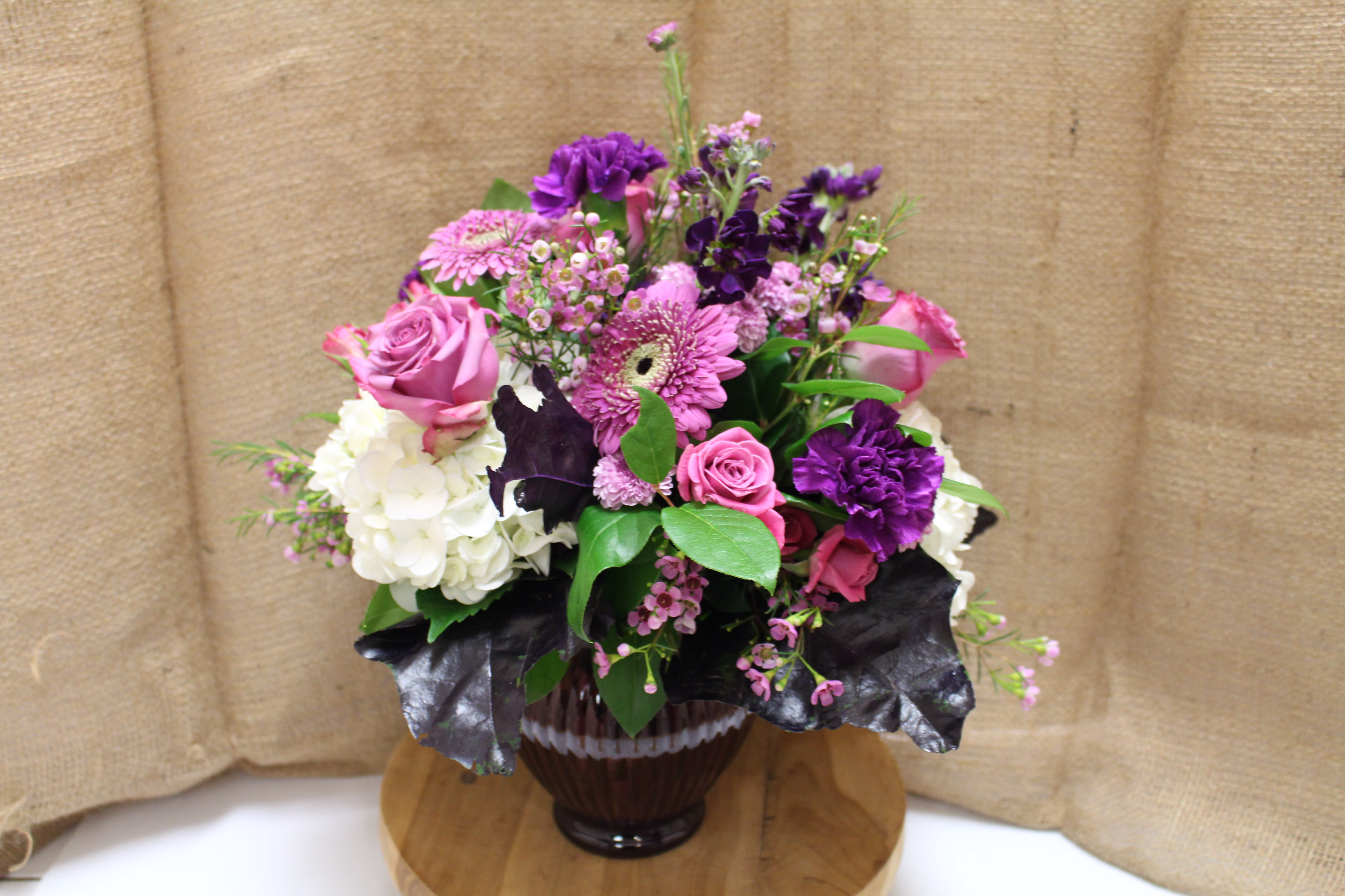 Pink and purple mixed bouquet in a glass vase